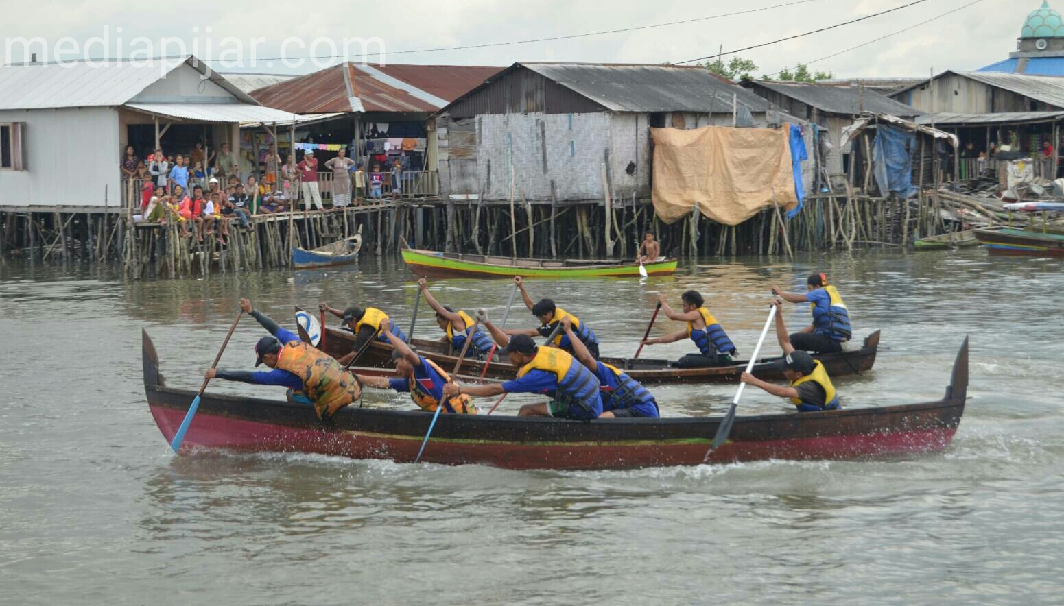 Berlomba untuk bisa mendapatkan posisi pertama dalam lomba dayung di Kampung Nelayan. (Fotografer : Muhammad Kurniawan)